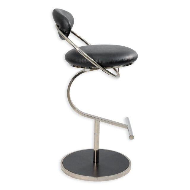 Sleek and sculptural, these high-top barstools by the Design Institute of America embody modern sophistication. Featuring...