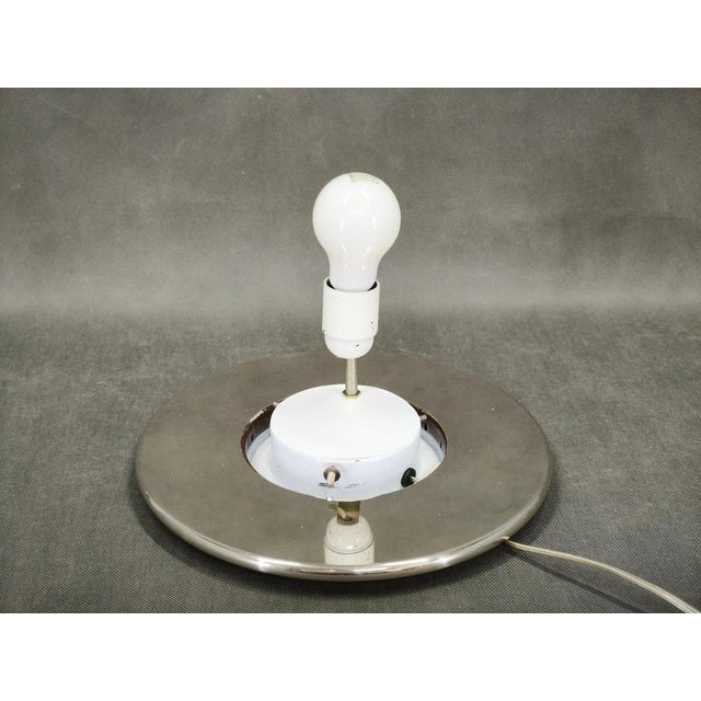 Large Italian Space Age table lamp from the 1970s, featuring a spherical Murano glass shade set on a minimalist chrome-...