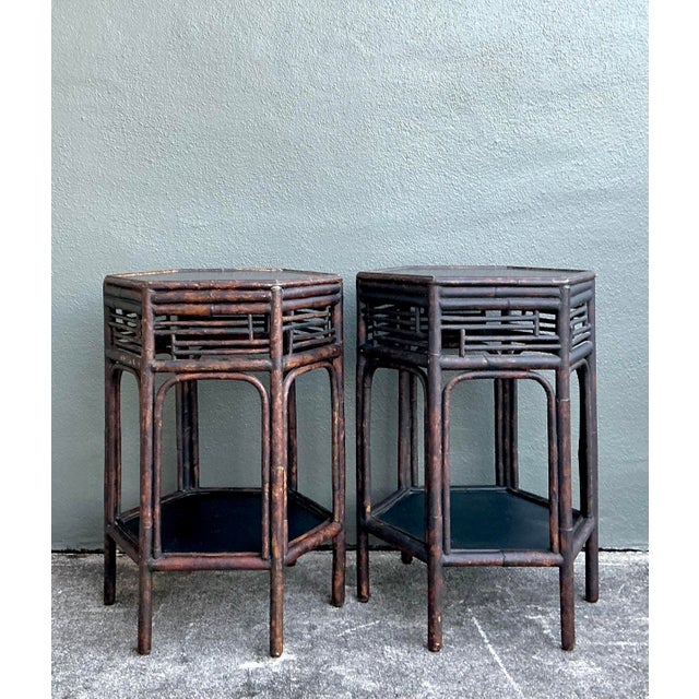 Infuse your home with the organic warmth and architectural allure of this pair of vintage burnt bamboo side tables. A...