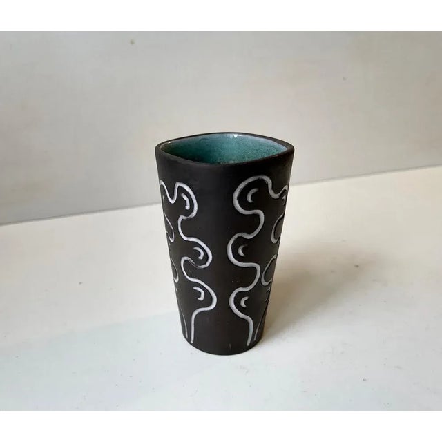 Ceramic vase decorated in glaze with abstract motif and interior green glaze. Designed by the danish ceramist Helge...