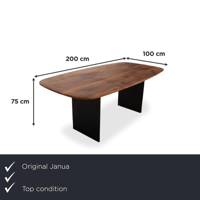 Here you get a dining table from the Basket series by Janua, which, with its solid wood top and black metal frame, adds a...