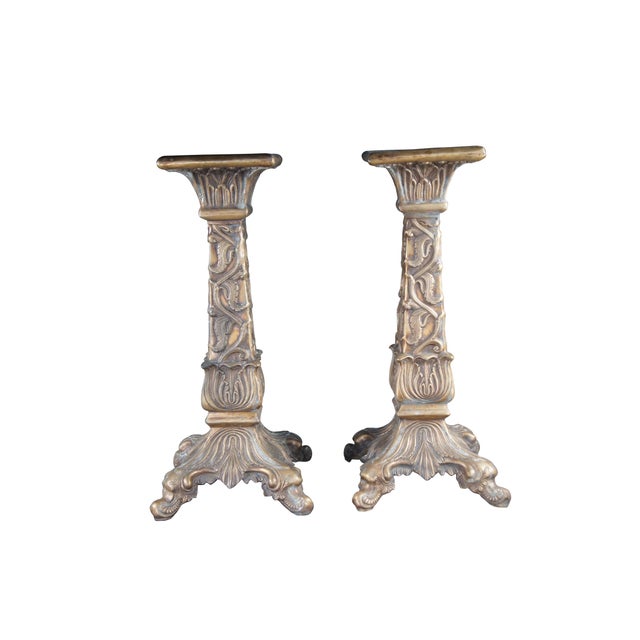 Pair bronze candle stands or sculpture pedestals. Features foliate and acanthus low relief details over an ornate four...