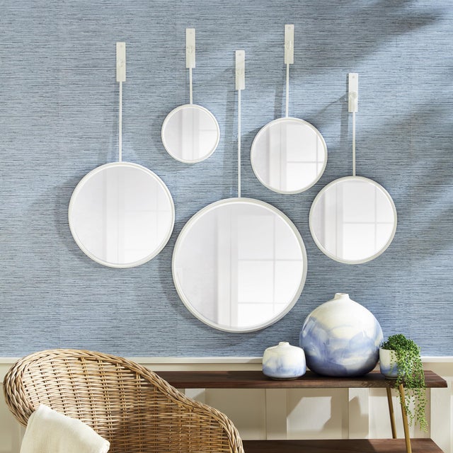 This unique set of five round mirrors are a great way to add interest and a reflective element to a room. The matte...