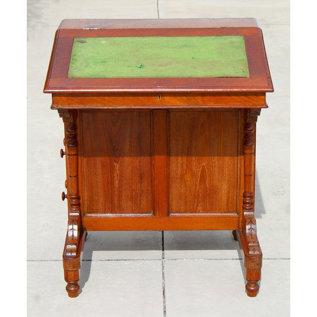 Bring timeless Victorian craftsmanship into your home with this authentic 19th-century English Davenport writing desk,...