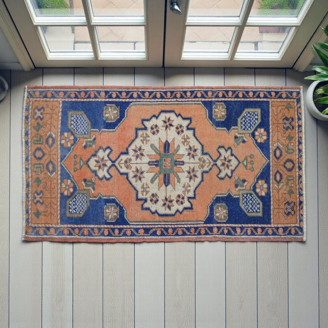 This vintage Oushak rug captures the essence of Aegean craftsmanship with its warm, sun-faded palette and classic...