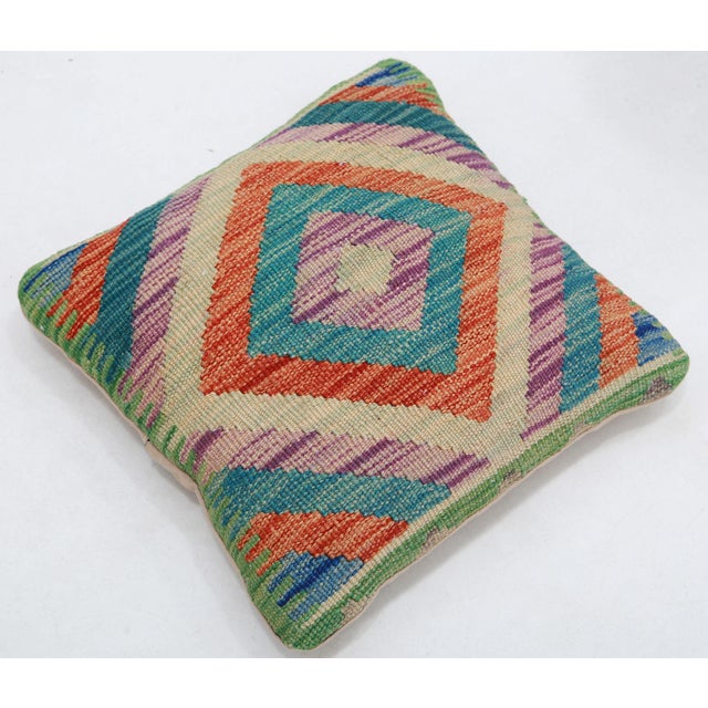 A one-of-a-kind handwoven Afghan wool kilim accent pillow featuring vivid concentric diamond. Cut and sewn by hand from a...