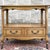 A vintage French Louis XV blond walnut drop leaf serving cart or bar cart having a shaped top and apron over an open...