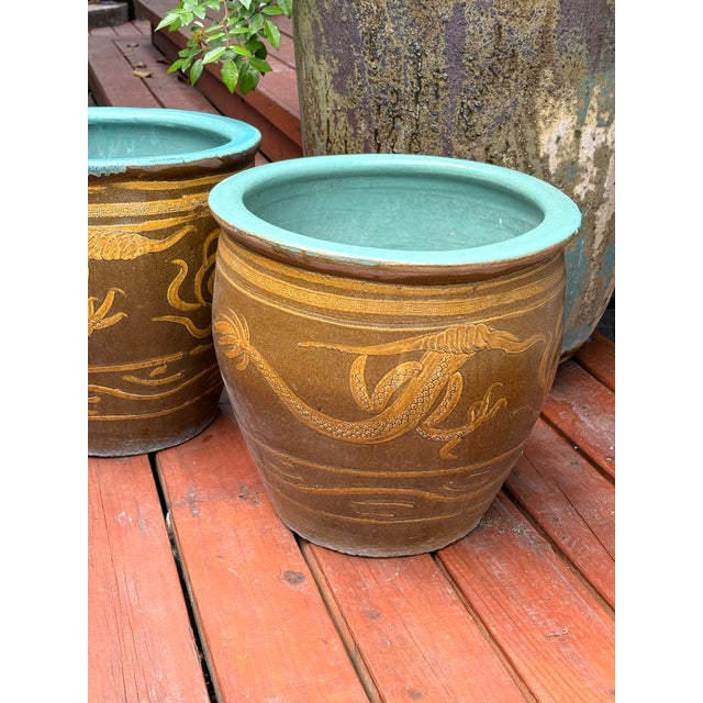 Set of 2 - Chinese Glazed Earthenware "Egg Pot" Jardinière Planter featuring an embossed imperial dragon motif....