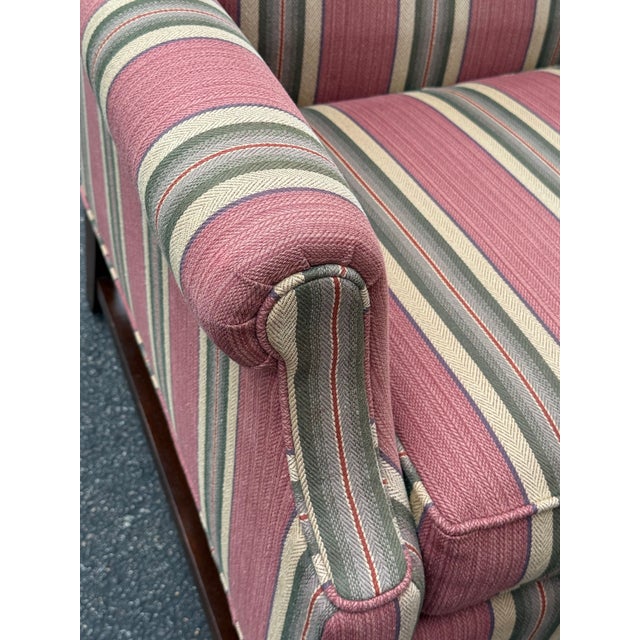 Classic wingback chair by Pennsylvania house. Features block legs, rolled arms and striped upholstery. Matching ottoman...