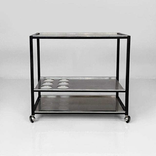 Italian modern cart with bottle holder in steel and black metal, 1980s Cart with three rectangular tops in steel. The...