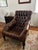 A big, generous leather chair built for sinking into with a book and a glass of wine. Deep diamond tufting covers the seat...
