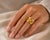 18k Hand fabricated yellow gold Etruscan style gold ring featuring 4 square cut fine rubies weighing 1.00 carat and five...