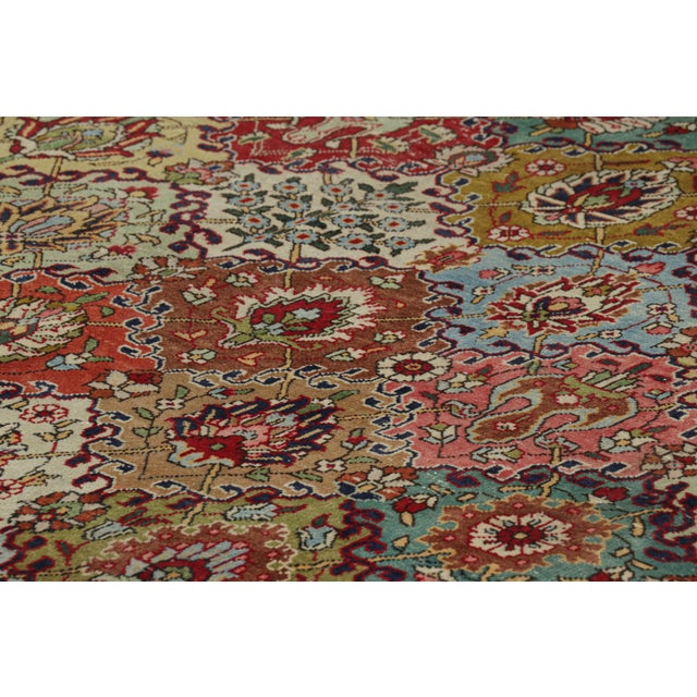 Made with hand-knotted wool and originating circa 1970-1980, this 10x13 vintage Tabriz rug represents a distinguished...