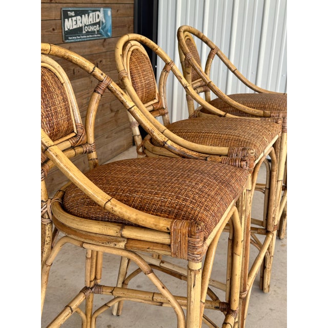 Vintage set of three rattan barstools with rattan weave seats and backs great for a coastal Old Florida style. Fabulous...