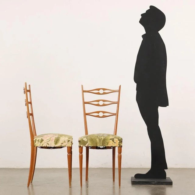 Pair of beechwood chairs with sprung upholstery and fabric cover. This piece is attributed to the mentioned...