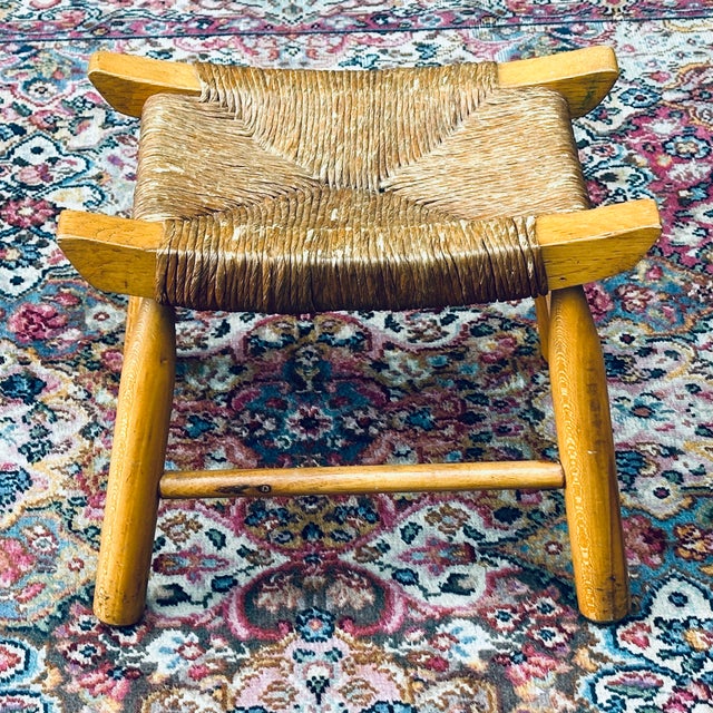 Charming vintage French Country footstool handcrafted from solid ash wood features a curved saddle seat of woven rush....