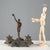 Inkwell in patinated bronze, embossed and chiseled. Base and ampoule holder with leafy scrolls, central figure of an...