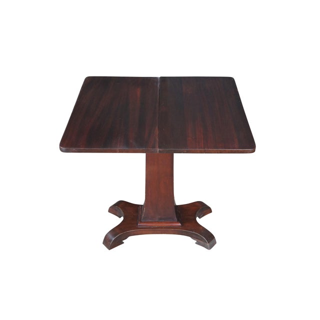 Antique Victorian flip top game table or console. Made of mahogany featuring American Empire styling with rectangular...