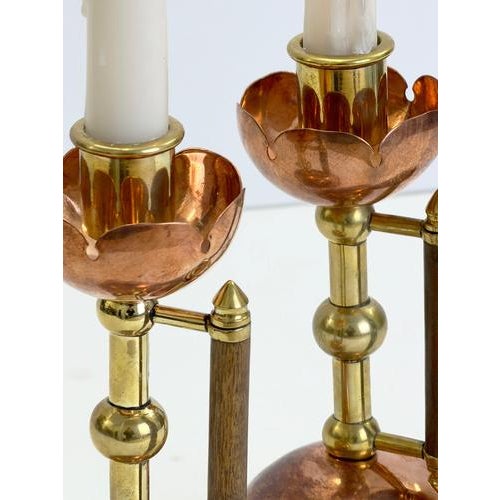 A striking pair of Arts and Crafts candlesticks by Benham & Froud, England, circa 1880, based on a design associated with...