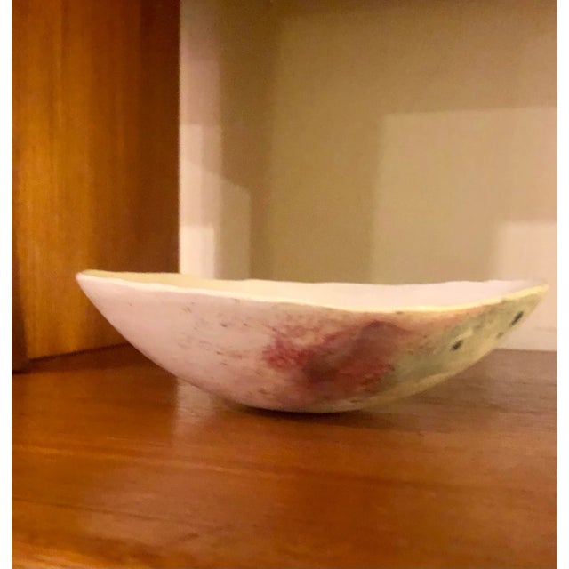 Beautiful studio pottery asymmetric bowl measuring roughly 2” tall by 6.5” wide. Maker’s mark on the bottom. This has an...