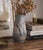 Porcelain vase produced by bing & grøndahl in denmark. executed with a hand-painted landscape motif in muted earth tones...