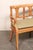 An Italian three-chair back fruitwood sofa bench, with cane seat and cushion, from the mid 20th century. This vintage...