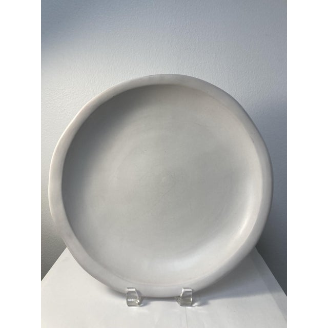 Set of five pieces of white Luna Garcia "Gigante" terra cotta stoneware; consisting of four 13" plates and one 20" x 15...