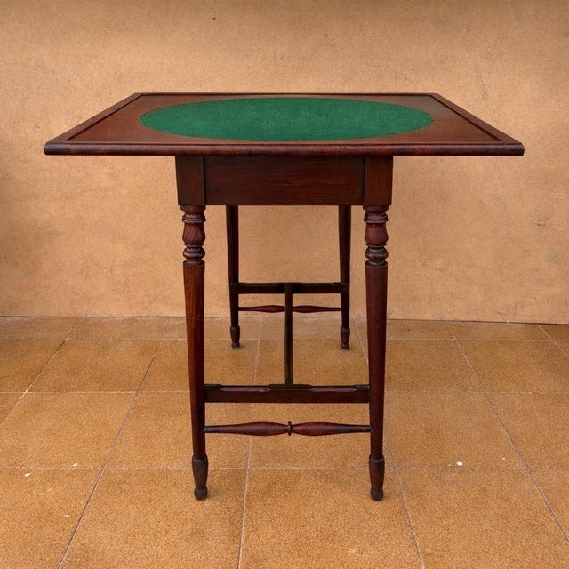 Elegant English games table crafted in solid oak, dating from the 20th century. The table features a rectangular top with...