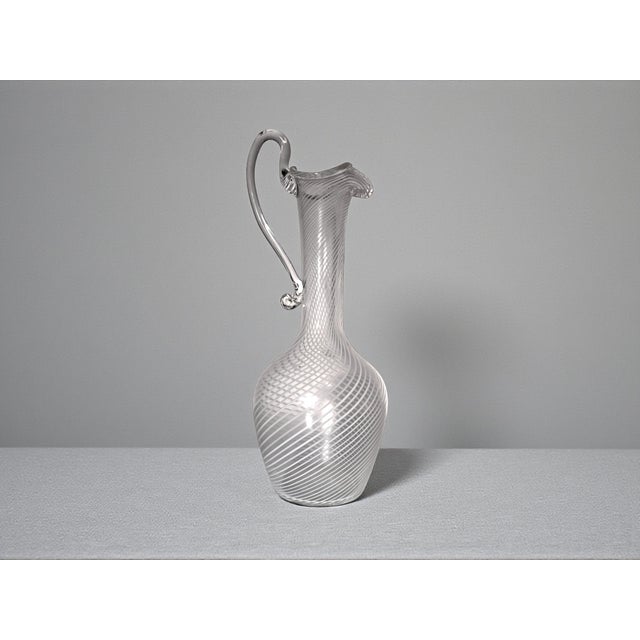 Blown glass carafe with a charming white spiral motif known as filigree; handcrafted by master glassmakers on the island...