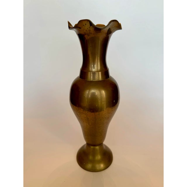 A French provincial style feminine form of a delicate scalloped top rim, a curved body enhances this solid brass vase. The...