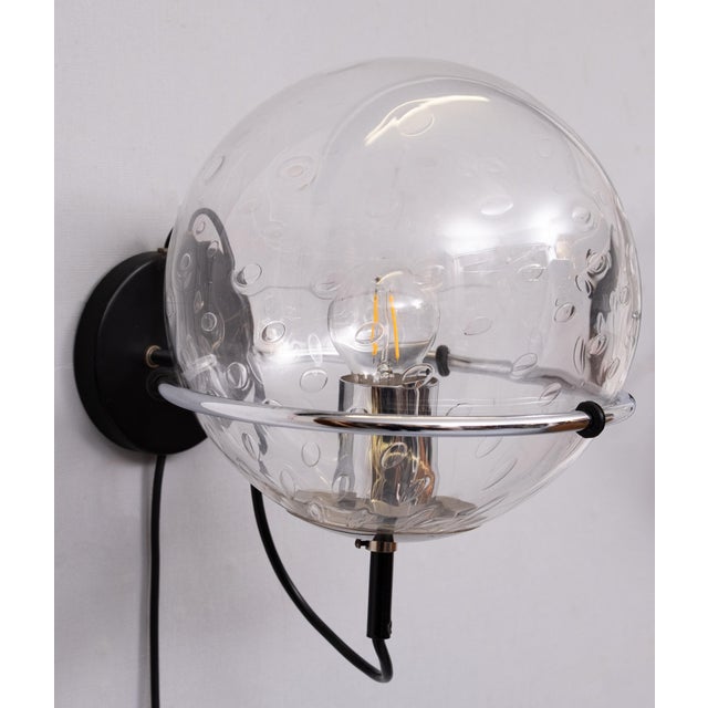 Beautiful pair of Raak Amsterdam model C-1725 globe raindrop wall lamp by 1970. The design creates a spectacular play of...