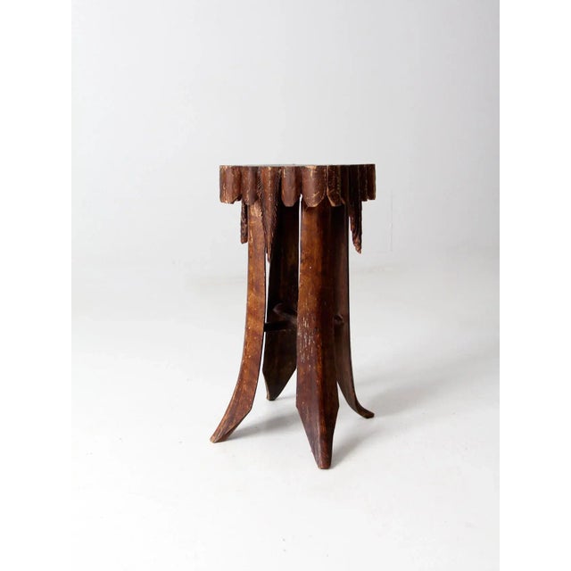 A charming example of early 20th-century tramp art, this accent table features four sculptural legs carved in the shape of...