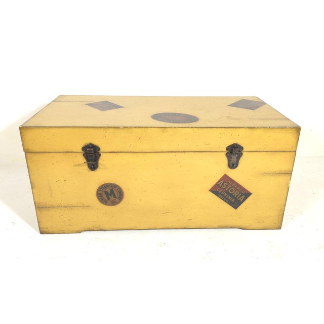 Offered is this lovely storage trunk in antique yellow paint. It has reproduction hotel travel labels that add to its...