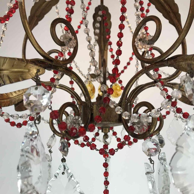 Antique chandelier with red crystals, made of wrought iron and lacquered, decorated with red and clear crystals. Five...