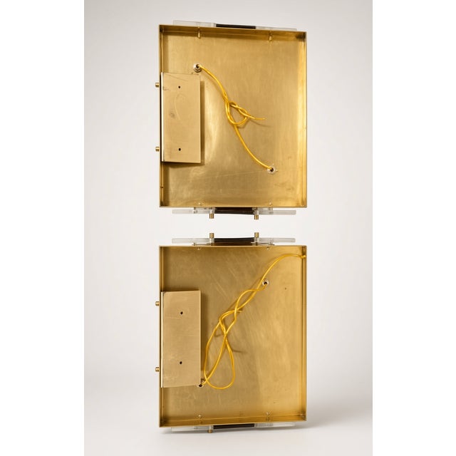 Sourced while visiting Italy. A pair of Italian glass wall sconces; each one is a rectangular shade with a wide amber band...