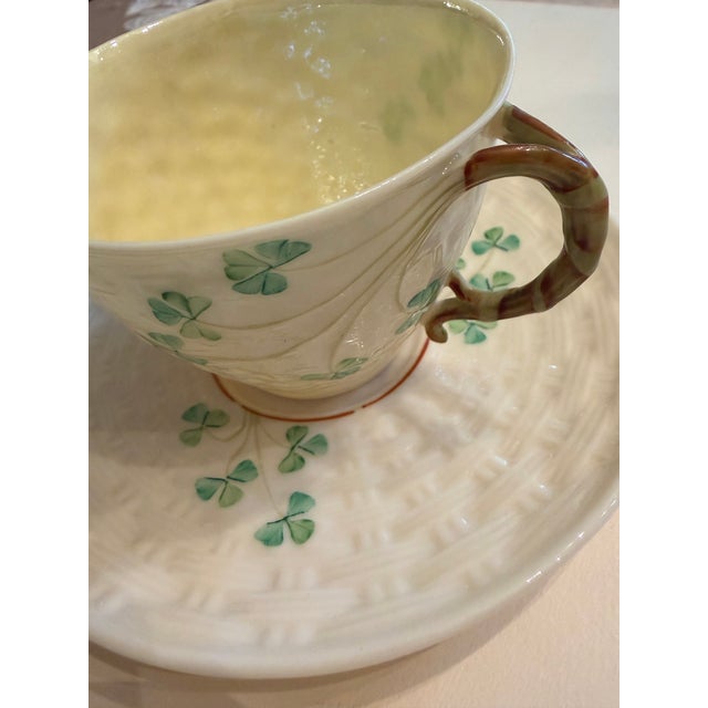 Beautiful Parian China with handpainted shamrocks descending from the twisted style vine teacup handle. The saucer and...