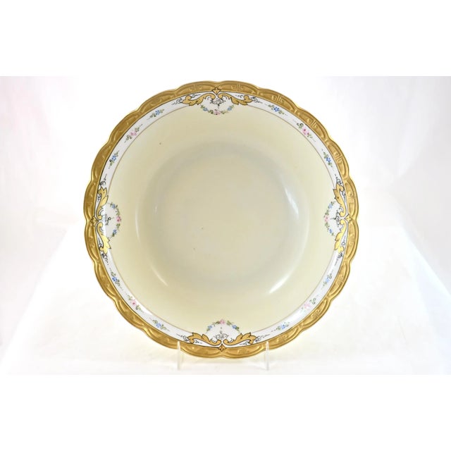Ornate porcelain bowl with a heavily gold gilt and a spring floral pattern, circa 1920. Maker attributed to...