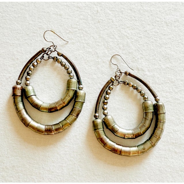 Vintage boho chic statement earrings featuring nested double hoop forms in antiqued mixed metals and patinated silver tone...
