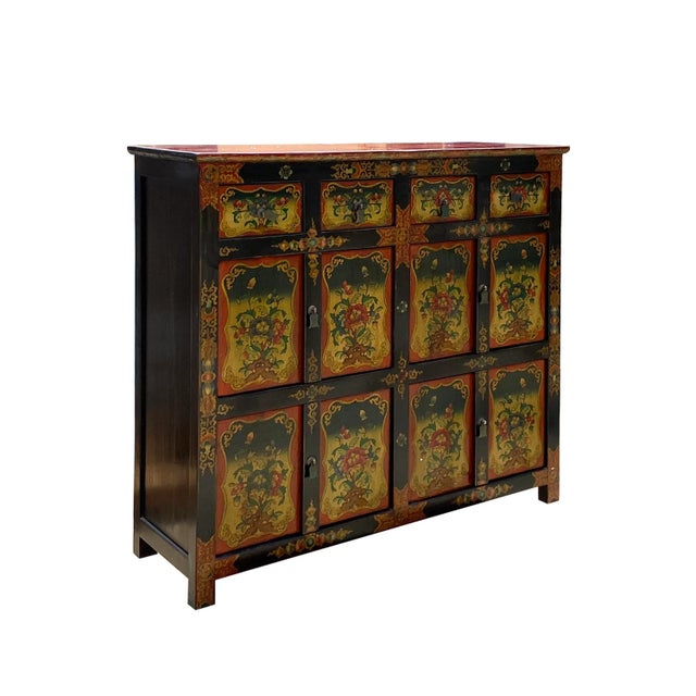 This is a medium-tall cabinet with a colorful Tibetan-style flower graphic at the front as a decorative accent. It can be...