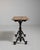 A sturdy bistro table with an ornate cast iron base reflecting Victorian craftsmanship. The durable construction ensures...