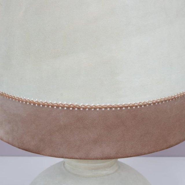 This striking 1970s French table lamp showcases a distinctive suede-upholstered base and hood, reflecting the era’s...