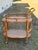This is a vintage rattan bar cart / tea trolley, a classic coastal piece with a light, airy presence. It features a...