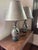 pair of black porcelain lamps with silver shades. Two prong plugs that work. 250V Minor scratch on shades