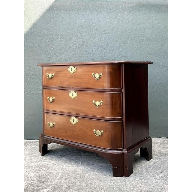 This exquisite mahogany bow-front chest of drawers captures the refined grace and timeless elegance of the English Regency...