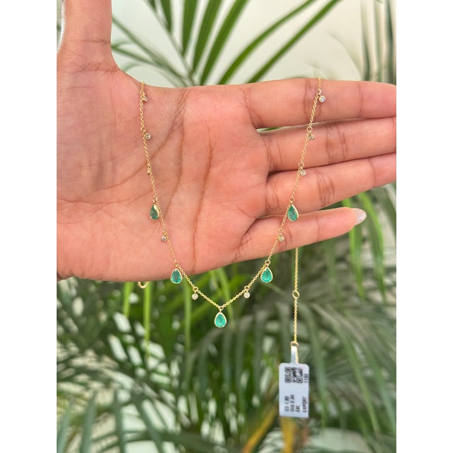 This station necklace features a 1.86 carats, crafted in 14K yellow gold. Each delicately set in smooth bezel settings and...