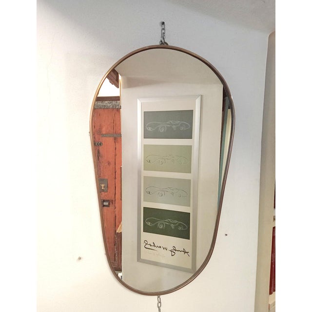 This mirror is in the manner of Gio Ponti for Fontana Arte, for form and style. This piece is attributed to the mentioned...