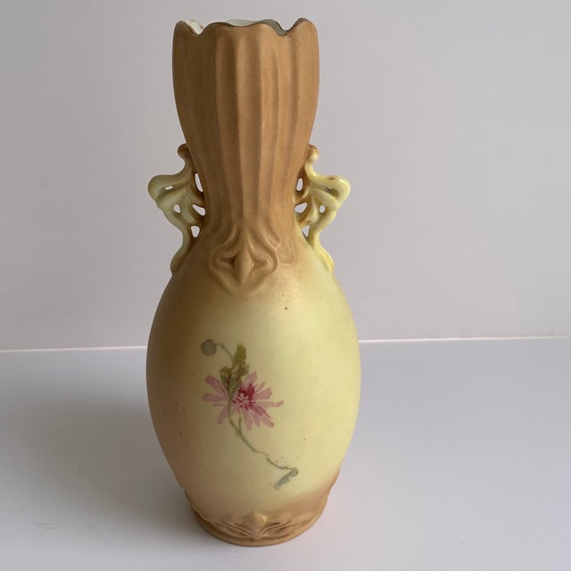 This piece has an appealing antique bisque color spectrum of deeps, taupe to ivory, created by Rudolstadt showcasing...