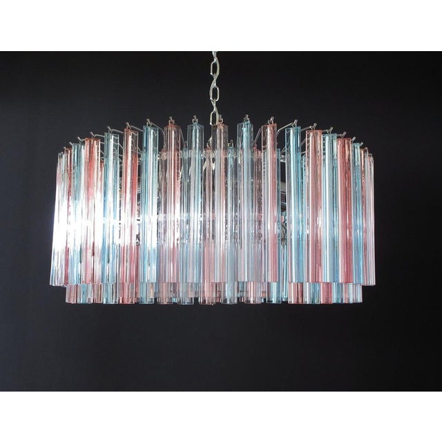 A magnificent murano glass chandelier, 265 pink and blue triedri on crome frame. This large mid-century italian chandelier...