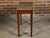 A French walnut console table from the 19th century with rectangular variegated marble top, single drawer and tapered...
