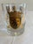 A stylish set of eight vintage lowball glasses decorated with gold heraldic crest motifs and ornate scrollwork. The...
